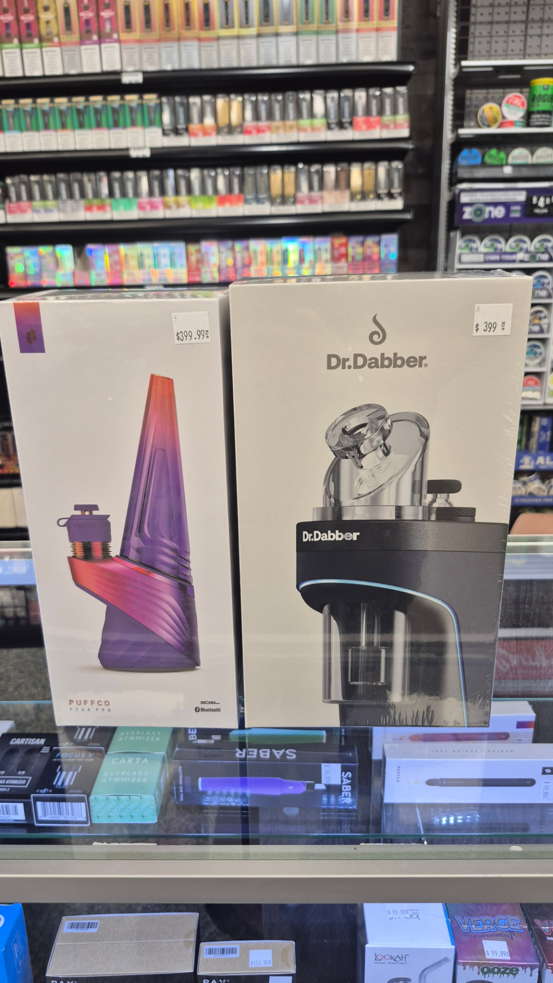 Puffco Peak Pro and Dr. Dabber e-rig boxes on the display case at The Hub
