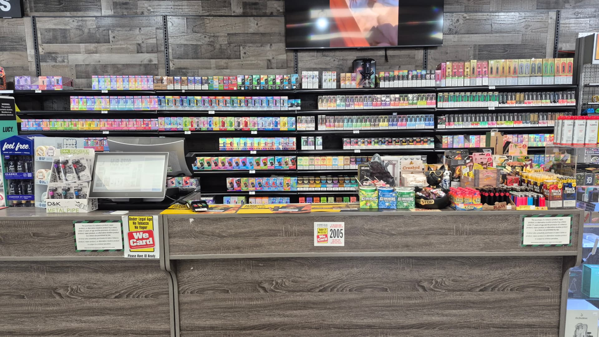 Wall of disposable vapes behind the counter at The Hub