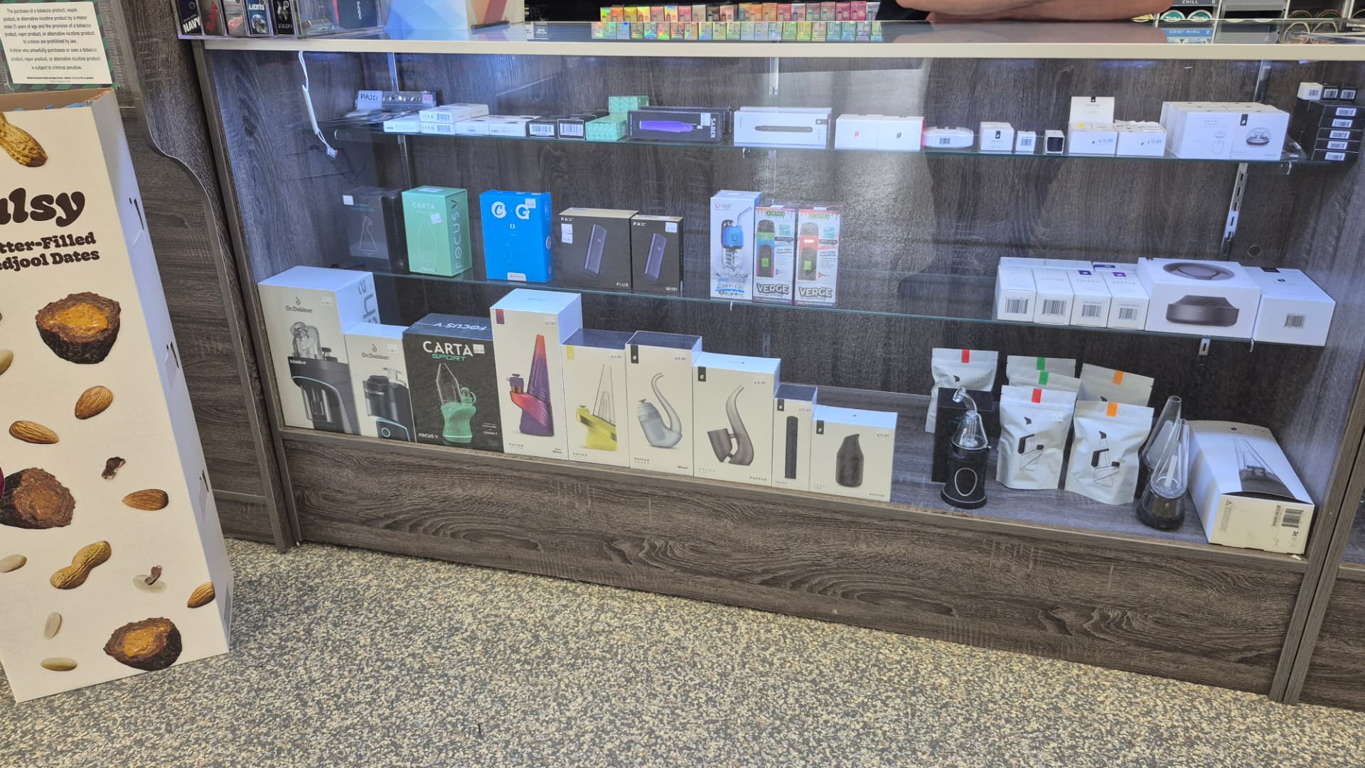 Display case of e-rigs, vaporizers and replacement atomizers at The Hub